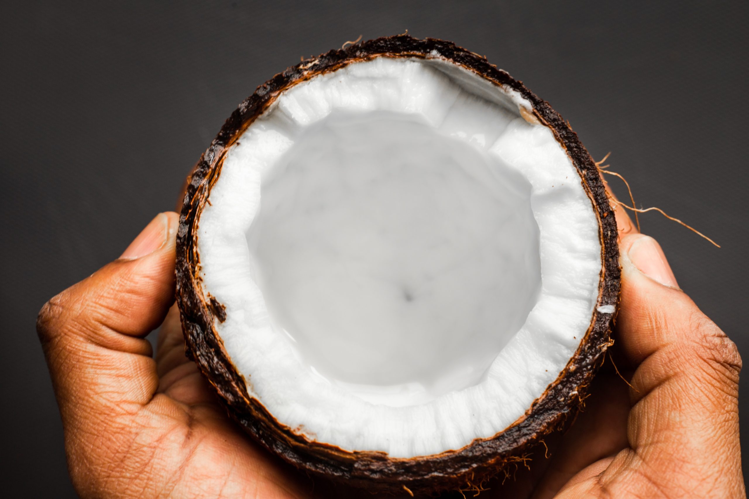 hands holding coconut