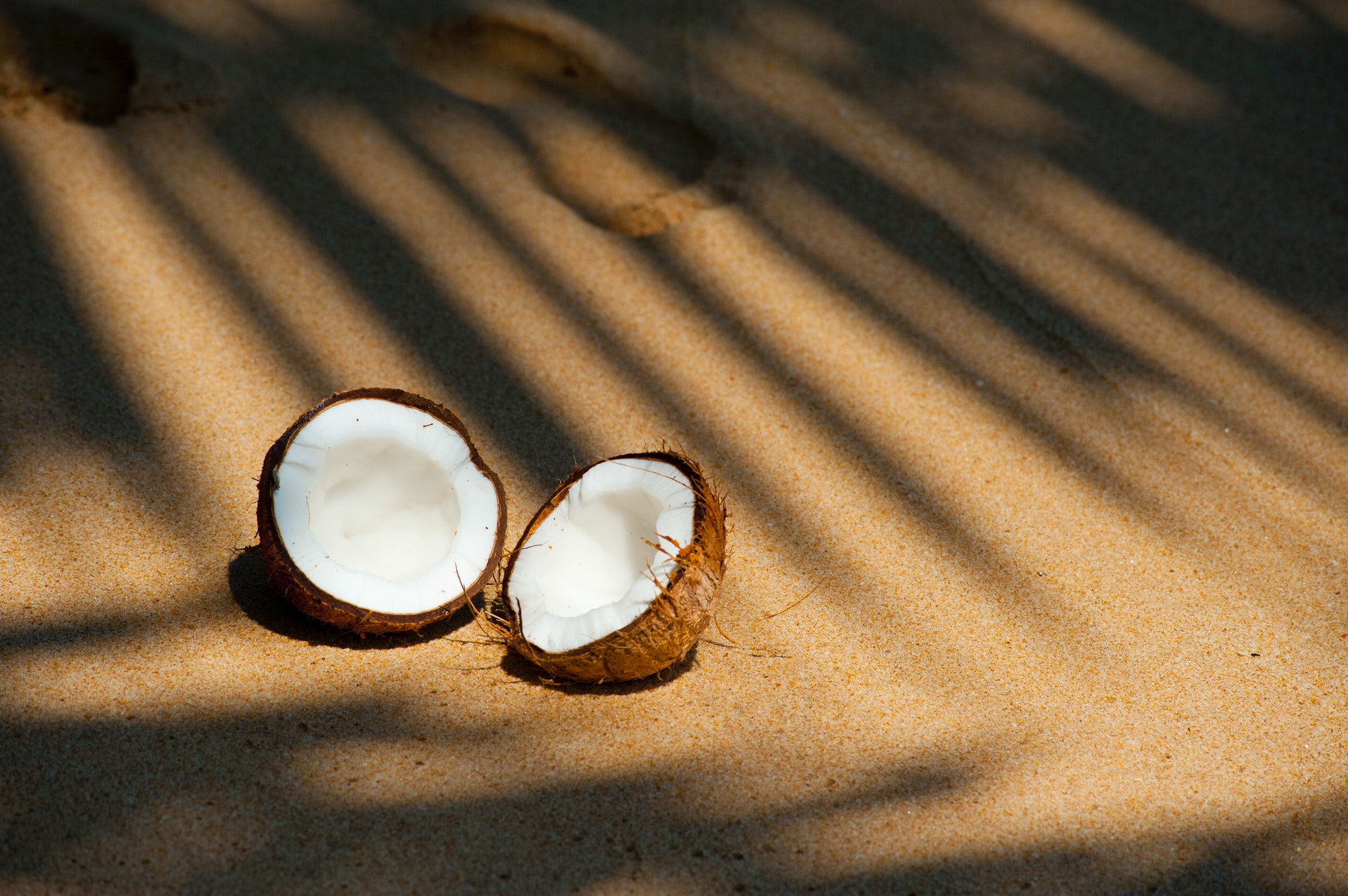 broken coconut on sand