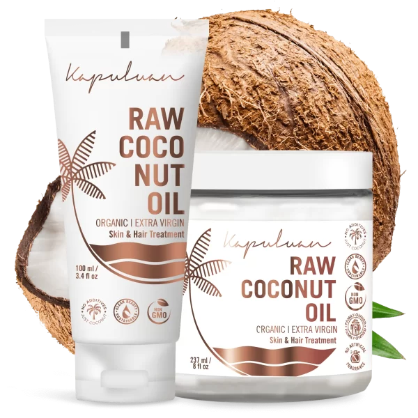 Two Kapuluan Cold-Pressed Raw Coconut Oil products for skin and hair are beautifully displayed—one in a tube, the other in a jar. Both are organic and extra virgin, set against a backdrop of a cracked coconut and lush green leaf to highlight their purity.