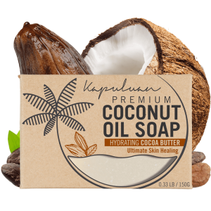 A bar of Coconut Oil Soap with Exfoliating Oatmeal, featuring hydrating cocoa butter, displayed with a cracked coconut and cocoa pod. The packaging emphasizes its ultimate skin healing benefits.