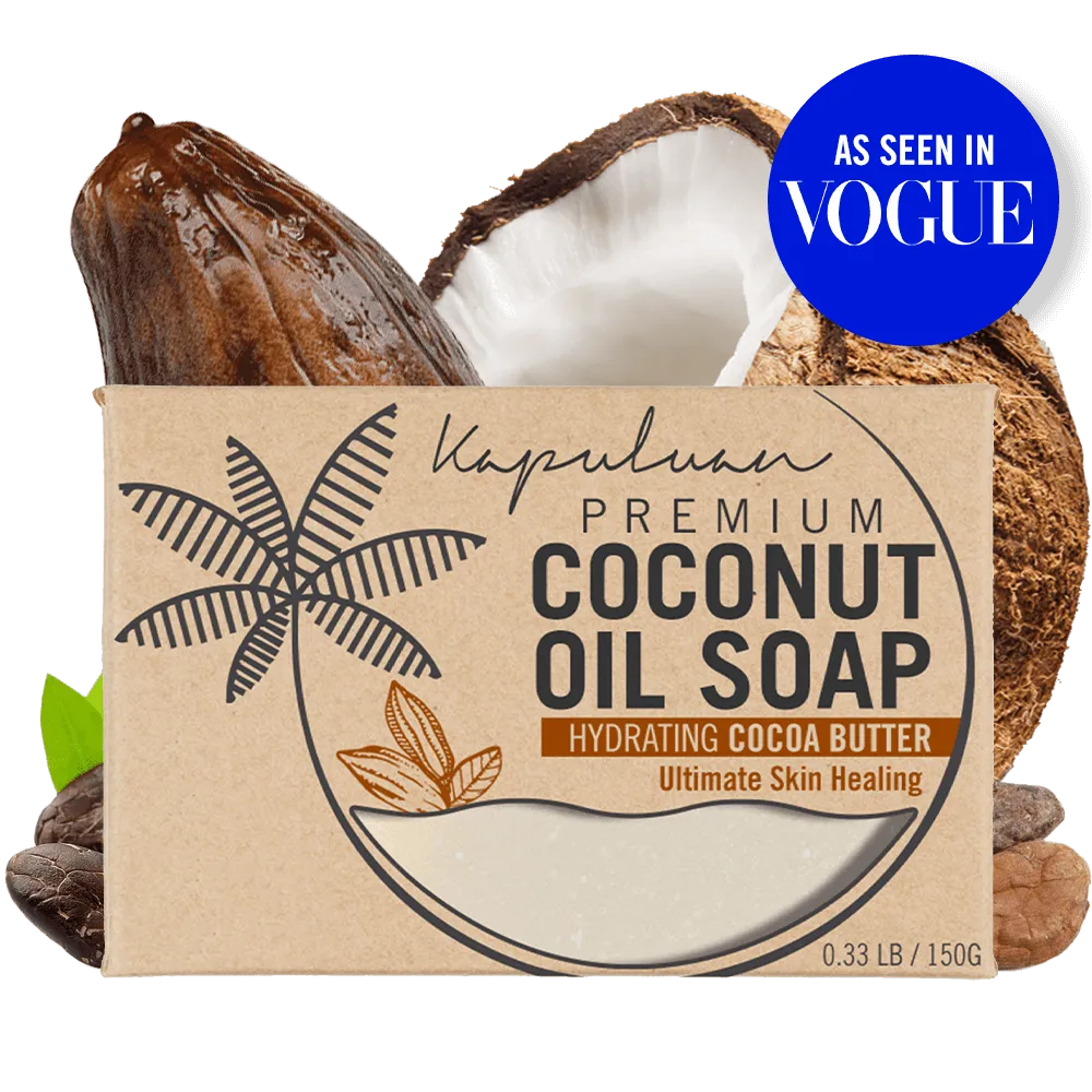 A bar of Coconut Oil Soap with Hydrating Cocoa Butter is displayed against a background featuring a split-open coconut and cocoa beans. The packaging includes the text "As Seen in Vogue" in a blue circle on the top right corner.