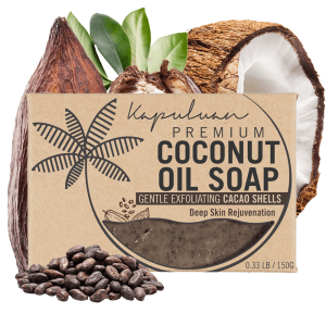 A bar of Coconut Oil Soap with Exfoliating Oatmeal is displayed with coconut shells, cacao pods, and beans in the background. The packaging emphasizes its gentle exfoliation and deep skin rejuvenation qualities.