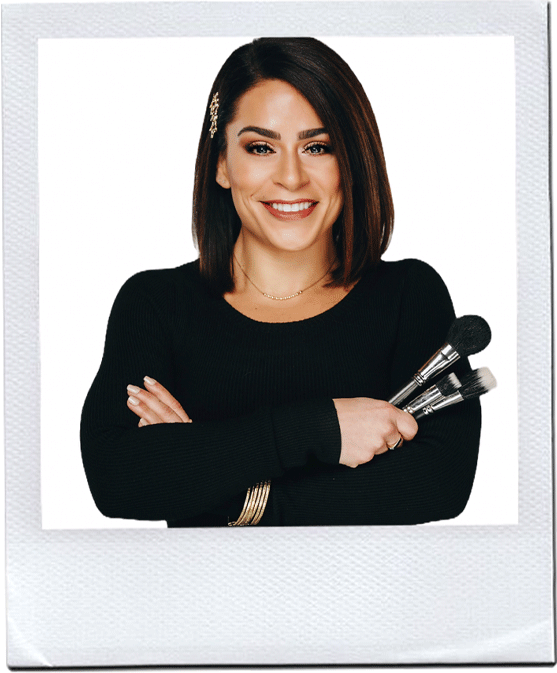 A confident woman with a warm smile, holding a set of coconut-infused makeup brushes, ready to showcase her beauty expertise.