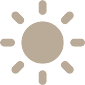 Silhouette of a simple, stylized cross with wide arms and a long stem, presented in a light brown color against a transparent background.