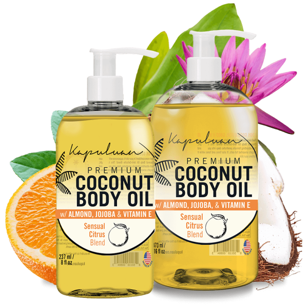 Two bottles of Sensual Coconut Body Oil with almond, jojoba, and vitamin E; featuring a citrus blend label. Background includes coconut halves, orange slices, and a pink lily.