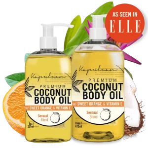 Two bottles of Sensual Coconut Body Oil are displayed, one 8 oz and the other 16 oz. The label reads "Premium Coconut Body Oil with Sweet Orange & Vitamin E, Sensual Blend." An orange slice, coconut pieces, and green leaves are in the background. A red "As Seen in ELLE" badge is visible.