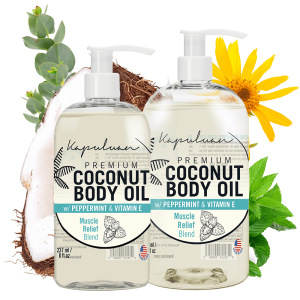 Two bottles of Sensual Coconut Body Oil are displayed with labels mentioning "Muscle Relief Blend." Coconut pieces, mint leaves, and Arnica flowers are arranged around them.