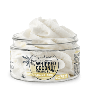 A jar of premium whipped coconut shaving butter, labeled as "silky & ultra-soft shave," displayed against a white background with visible fluffy texture inside the open jar.