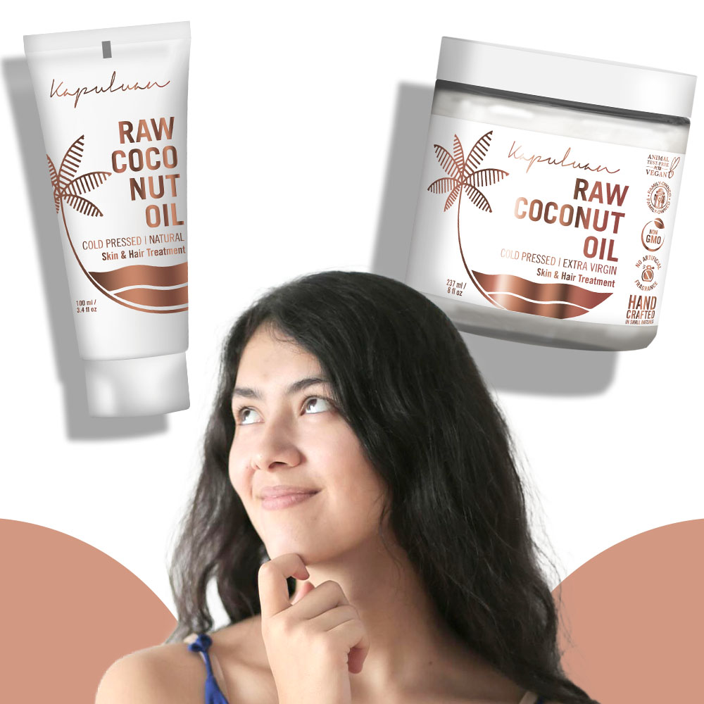 A woman with long dark hair is looking up thoughtfully. Surrounding her are two Kapuluan products: a tube of raw coconut oil and a jar of raw coconut oil. Both products are labeled for skin and hair treatment. The background has soft pink accents.