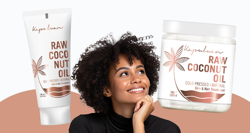 A smiling woman with curly hair looks at two products labeled "raw coconut oil" for skin and hair care, displayed against a light background.