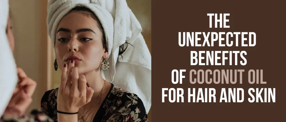 A person with a towel on their head looks in a mirror, applying a product to their lips. They are wearing a dark floral top and earrings. Text on the right side of the image reads: "The Unexpected Benefits of Coconut Oil for Hair and Skin.