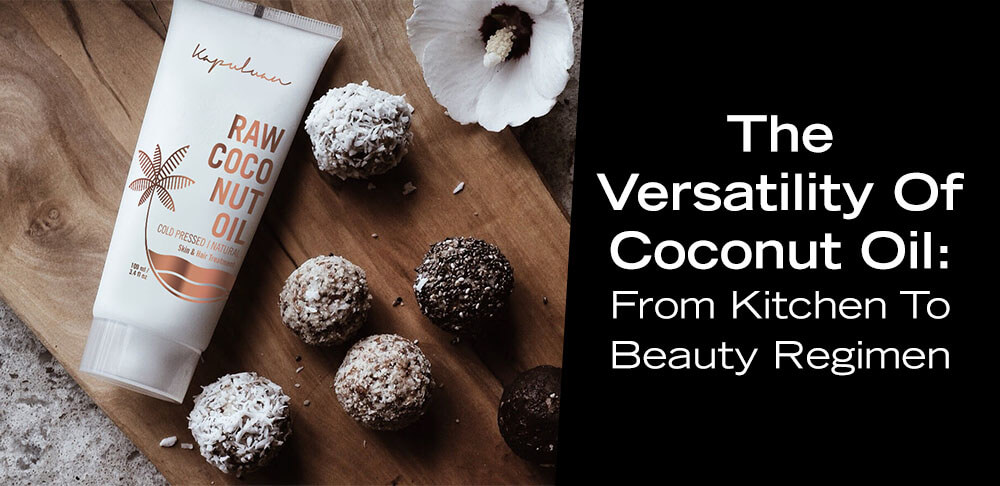 A bottle of raw coco nut oil lies beside coconut oil balls and a white flower on a wooden surface, with text "the versatility of coconut oil: from kitchen to beauty regimen.