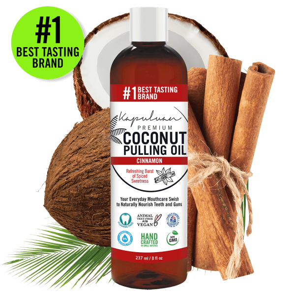 Displayed is a bottle of Coconut Pulling Oil - Cinnamon, surrounded by a coconut and green leaves, with the text "#1 Best Tasting Brand." The label highlights its vegan, non-GMO, and handcrafted qualities.