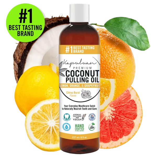A bottle of Coconut Pulling Oil - Citrus Burst, labeled "#1 Best Tasting Brand." The citrus burst flavor features lemon, orange, and grapefruit. The bottle is surrounded by slices of these fruits. Labels include "Vegan," "Non-GMO," and "Handcrafted.