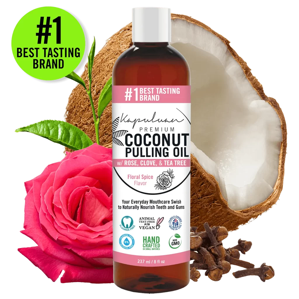 A bottle of Coconut Pulling Oil - Floral Spice is displayed in the center, surrounded by a halved coconut, a pink rose, and cloves. The label highlights floral spice flavor, vegan, non-GMO, and handcrafted certifications. "#1 Best Tasting Brand" is noted.