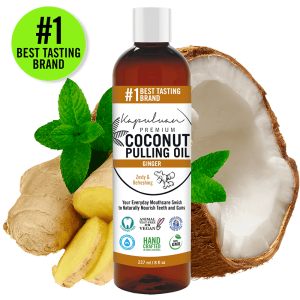 A bottle of Coconut Pulling Oil - Ginger is placed amidst fresh ginger, coconut, and mint leaves. The label showcases features such as vegan, non-GMO, and handcrafted. The text asserts it as the "#1 Best Tasting Brand".