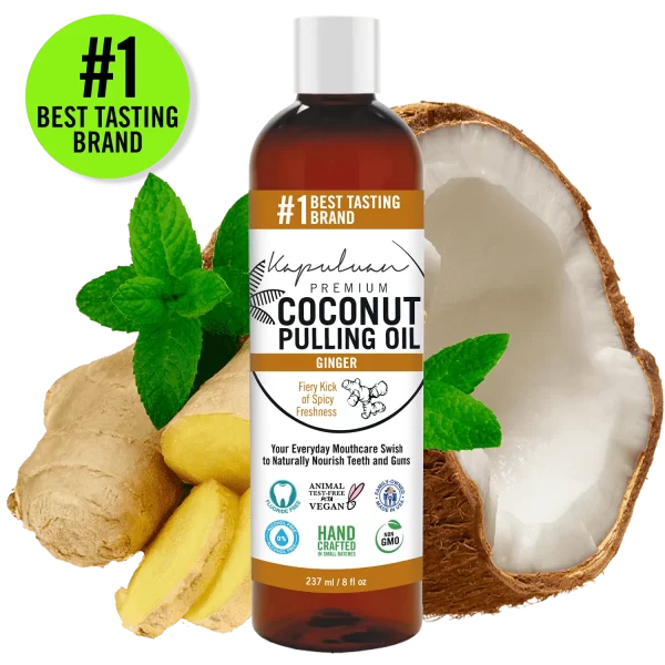 A bottle of Kapuluan Coconut Pulling Oil with Ginger at the center, surrounded by a halved coconut, ginger pieces, and mint leaves. The label highlights features like "Animal Friendly," "Vegan," "Handcrafted," and "Non-GMO." Discover the #1 Best Tasting Brand and enjoy the myriad coconut oil benefits.