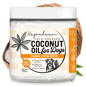 A jar of Kapuluan Coconut Oil for Dogs features a coconut and leaf design on the label, highlighting its organic, extra virgin, 100% natural, and non-GMO qualities. It's ideal for daily use and offers benefits for dry noses, paws, and dental health.